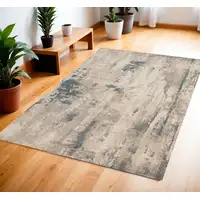 Photo of Ivory and Teal Blue Abstract Area Rug