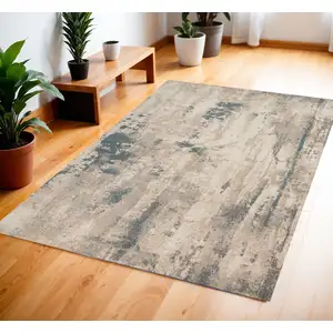 Photo of Ivory and Teal Blue Abstract Area Rug