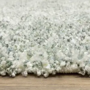 Photo of Light Blue And Ivory Abstract Shag Area Rug With Fringe