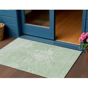 Photo of Mint Green And Ivory Abstract Washable Indoor Outdoor Area Rug