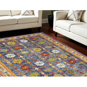 Photo of Navy Blue Orange And Green Wool Floral Hand Tufted Distressed Area Rug