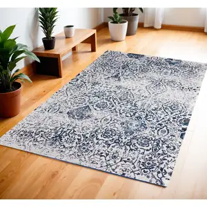 Photo of Navy Blue and Ivory Damask Distressed Area Rug