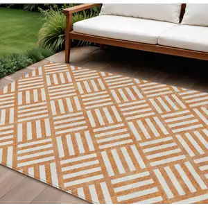 Photo of Orange And Ivory Geometric Washable Indoor Outdoor Area Rug