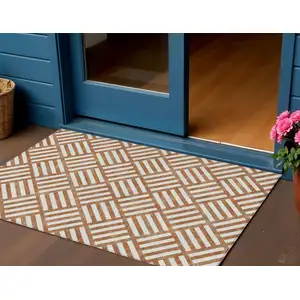 Photo of Orange And Ivory Geometric Washable Indoor Outdoor Area Rug