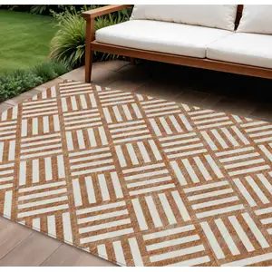 Photo of Orange And Ivory Geometric Washable Indoor Outdoor Area Rug