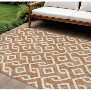 Photo of Orange And Ivory Geometric Washable Indoor Outdoor Area Rug