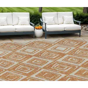 Photo of Orange And Ivory Geometric Washable Indoor Outdoor Area Rug