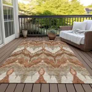 Photo of Orange Beige And Copper Ikat Washable Indoor Outdoor Area Rug