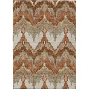 Photo of Orange Beige And Copper Ikat Washable Indoor Outdoor Area Rug