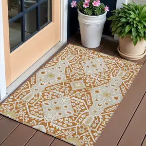 Photo of Orange Beige And Gold Floral Washable Indoor Outdoor Area Rug