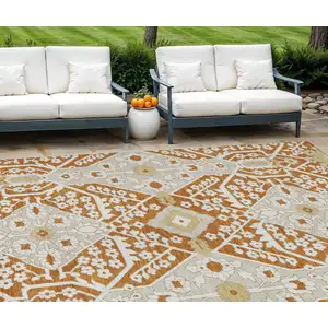 Photo of Orange Beige And Gold Floral Washable Indoor Outdoor Area Rug