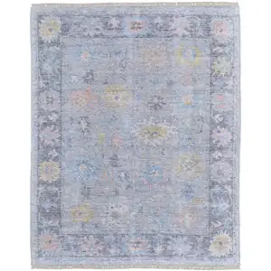 Photo of Orange Blue and Gold Floral Hand Woven Distressed Area Rug With Fringe