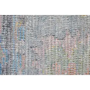 Photo of Orange Blue and Gold Floral Hand Woven Distressed Area Rug With Fringe