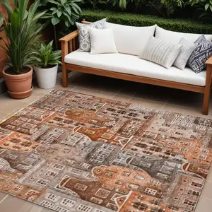 Photo of Orange Copper And Salmon Village Houses Washable Indoor Outdoor Area Rug