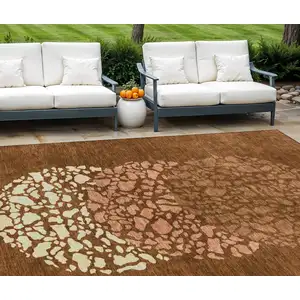 Photo of Orange Terra Cotta And Ivory Abstract Washable Indoor Outdoor Area Rug