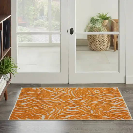 Orange And Ivory Abstract Stain Resistant Indoor Outdoor Area Rug Photo 6