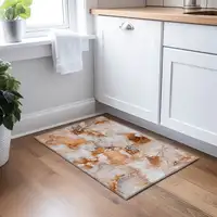 Photo of Orange and Ivory Abstract Washable Non Skid Indoor Outdoor Area Rug