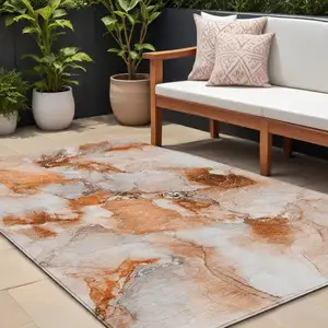 Photo of Orange and Ivory Abstract Washable Non Skid Indoor Outdoor Area Rug