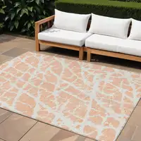 Photo of Peach and Ivory Abstract Washable Non Skid Indoor Outdoor Area Rug