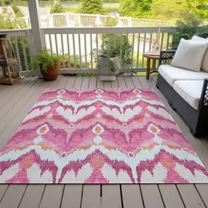 Photo of Pink Mauve And Orange Ikat Washable Indoor Outdoor Area Rug