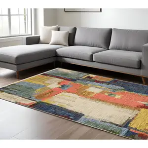 Photo of Pink Red And Yellow Abstract Area Rug With Fringe