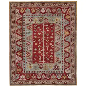 Photo of Red Blue And Brown Wool Floral Hand Knotted Distressed Stain Resistant Area Rug With Fringe