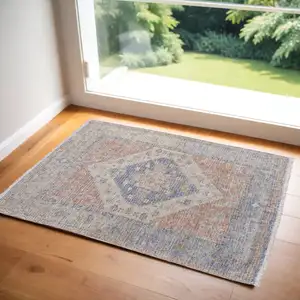 Photo of Red Blue and Ivory Abstract Hand Woven Distressed Area Rug With Fringe