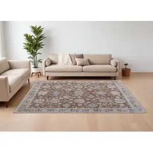 Photo of Red Blue and Ivory Floral Power Loom Worn Faded Area Rug With Fringe