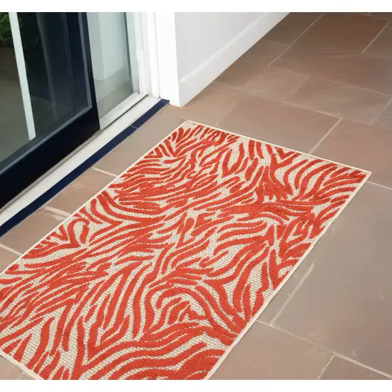 Red And Ivory Abstract Indoor Outdoor Area Rug Photo 1