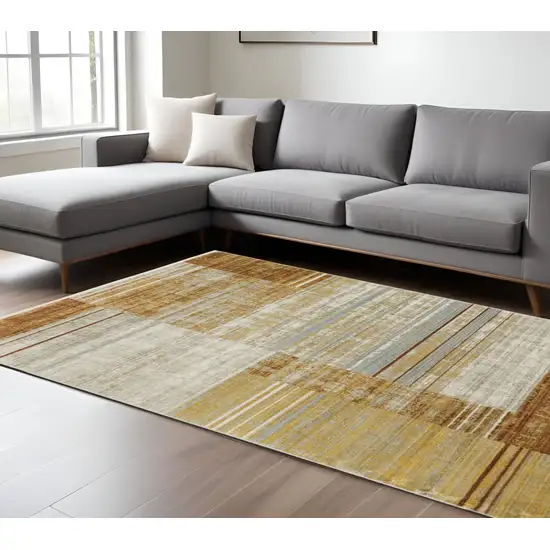 6' X 9' Rust Gold Blue Grey Ivory And Tan Geometric Power Loom Stain Resistant Area Rug With Fringe Photo 1