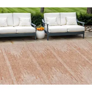 Photo of Salmon And Ivory Abstract Washable Indoor Outdoor Area Rug