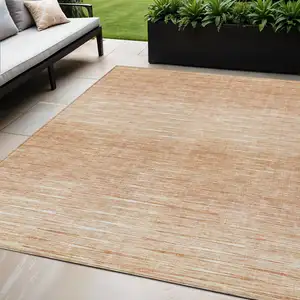 Photo of Salmon And Ivory Abstract Washable Indoor Outdoor Area Rug