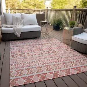 Photo of Salmon Beige And Copper Quatrefoil Washable Indoor Outdoor Area Rug