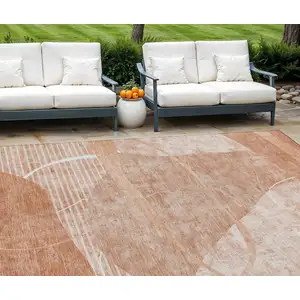 Photo of Salmon Copper And Ivory Abstract Washable Indoor Outdoor Area Rug