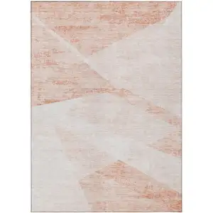 Photo of Salmon Peach And Ivory Abstract Washable Indoor Outdoor Area Rug