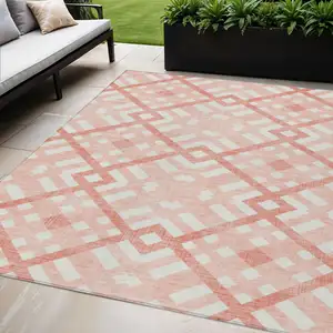 Photo of Salmon Peach And Ivory Geometric Washable Indoor Outdoor Area Rug