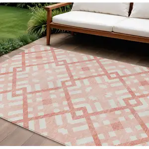 Photo of Salmon Peach And Ivory Geometric Washable Indoor Outdoor Area Rug