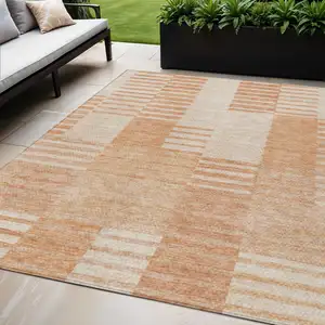 Photo of Salmon Peach And Ivory Striped Washable Indoor Outdoor Area Rug