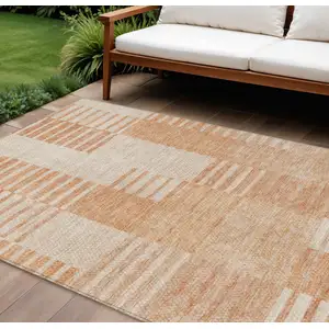 Photo of Salmon Peach And Ivory Striped Washable Indoor Outdoor Area Rug