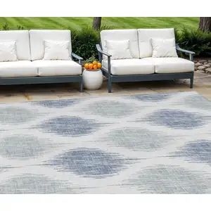 Photo of Sky Blue Ivory And Denim Blue Ikat Washable Indoor Outdoor Area Rug