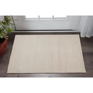 Photo of Tan Abstract Hand Woven Area Rug