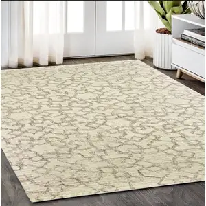 Photo of Tan And Ivory Wool Geometric Hand Tufted Area Rug