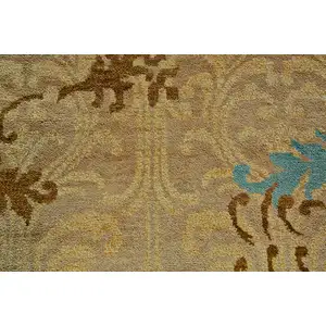 Photo of Tan Blue and Brown Floral Hand Knotted Area Rug