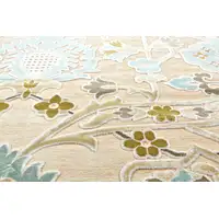 Photo of Tan Blue and Brown Floral Power Loom Worn Faded Area Rug