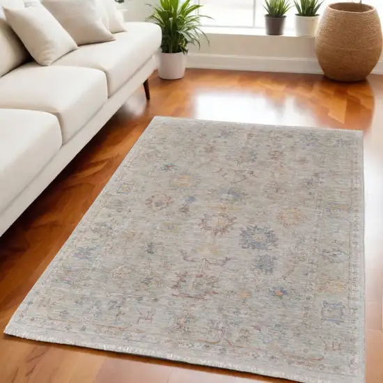 Tan Brown and Blue Floral Hand Woven Distressed Area Rug With Fringe Photo 1