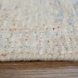 Photo of Tan Brown and Blue Floral Hand Woven Distressed Area Rug With Fringe