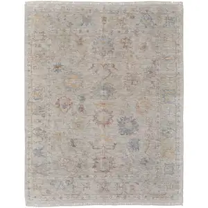 Photo of Tan Brown and Blue Floral Hand Woven Distressed Area Rug With Fringe