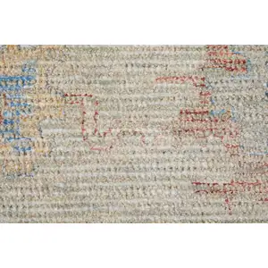 Photo of Tan Brown and Blue Floral Hand Woven Distressed Area Rug With Fringe