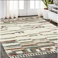 Photo of Tan Gray And Ivory Abstract Shag Distressed Area Rug With Fringe