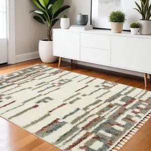 Photo of Tan Gray And Ivory Abstract Shag Distressed Area Rug With Fringe